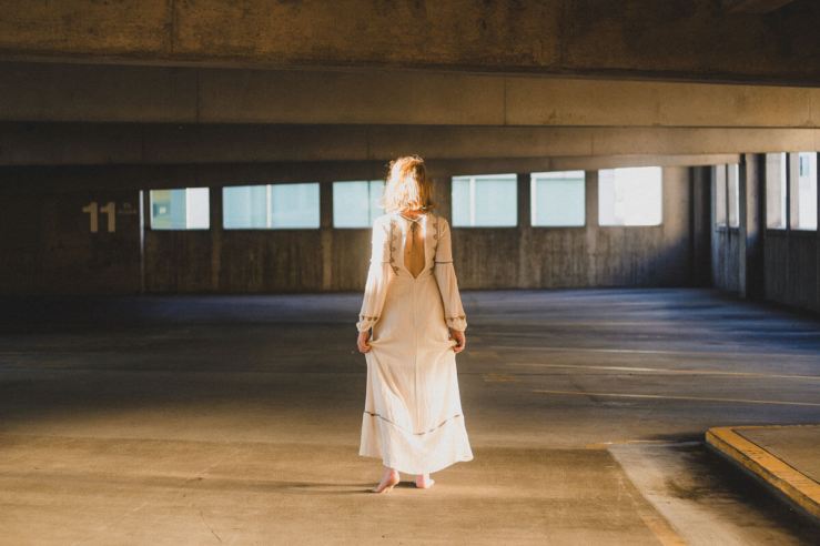 Madi K May in a white dress